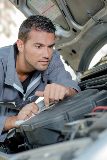Man fixing a car engine