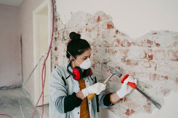 Picture of woman DIYer working on wall